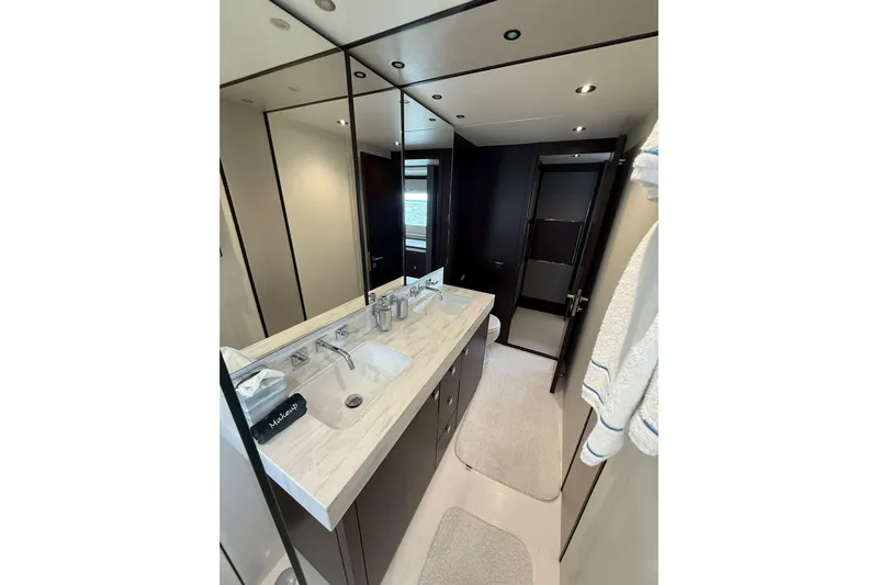  Yacht Photos Pics Luxurious bathroom interior of 2021 Sunseeker 76 Yacht with modern fixtures and elegant design.