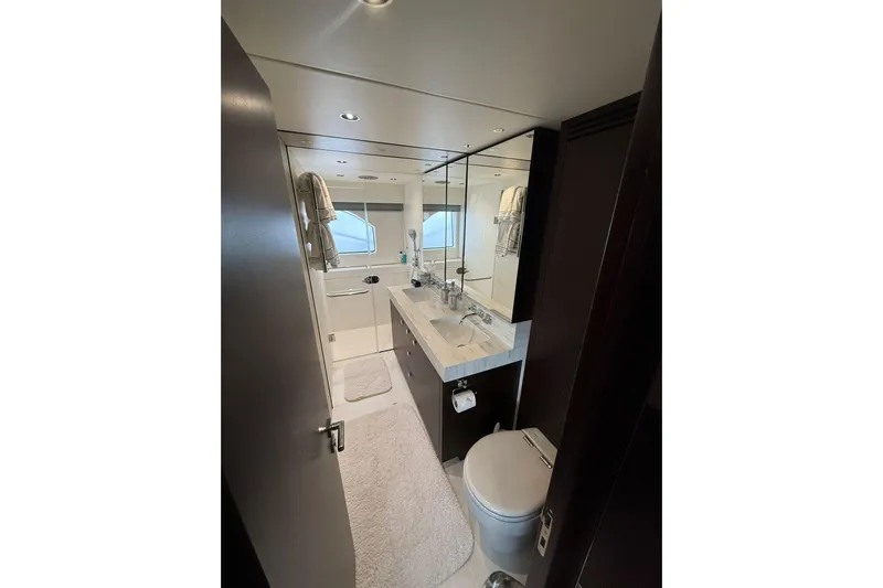  Yacht Photos Pics Luxurious bathroom in 2021 Sunseeker 76 Yacht with modern fixtures and elegant design.