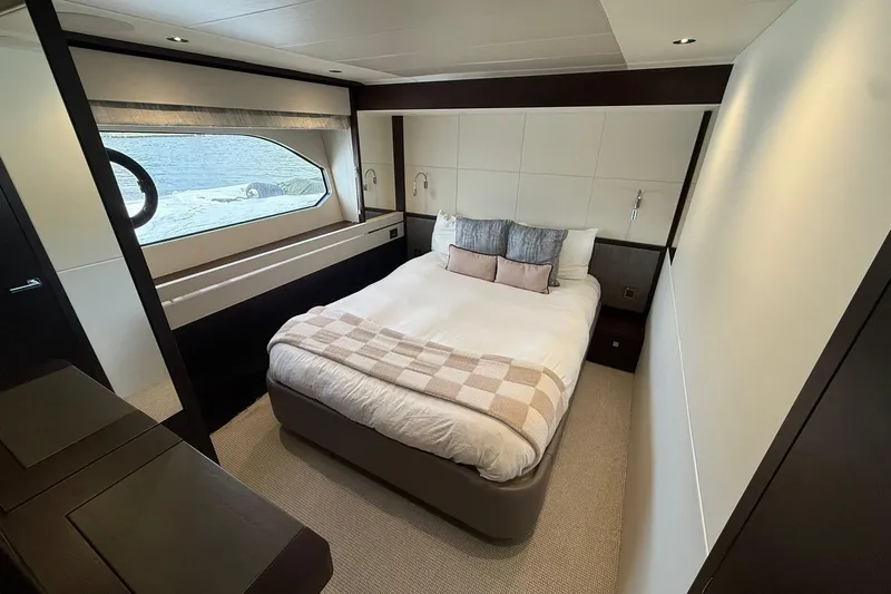  Yacht Photos Pics Luxurious bedroom interior of 2021 Sunseeker 76 Yacht with ocean view.