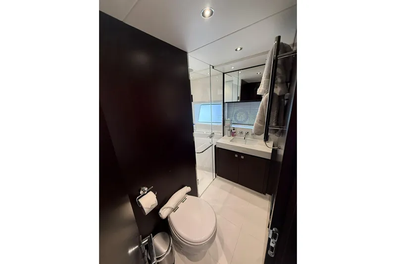  Yacht Photos Pics Luxurious bathroom in 2021 Sunseeker 76 Yacht with modern fixtures and elegant design.