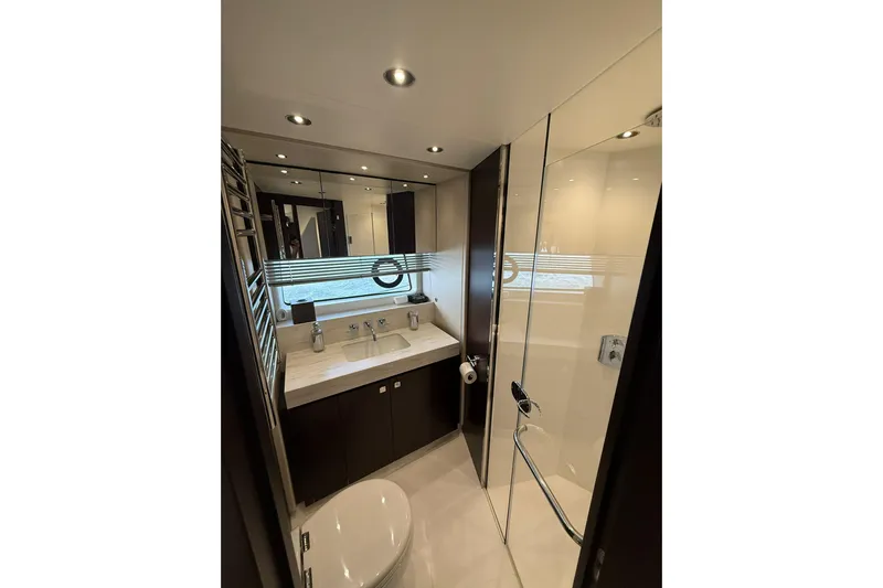  Yacht Photos Pics Luxurious bathroom in 2021 Sunseeker 76 Yacht with modern fixtures and elegant design.