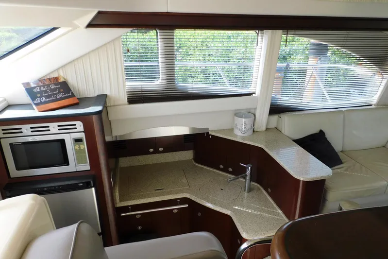 Full Deck Yacht Photos Pics Interior of 2008 Sea Ray 44 Sedan Bridge yacht with modern kitchen and seating area.