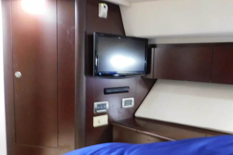 Full Deck Yacht Photos Pics Interior of 2008 Sea Ray 44 Sedan Bridge with TV and wooden cabinetry.