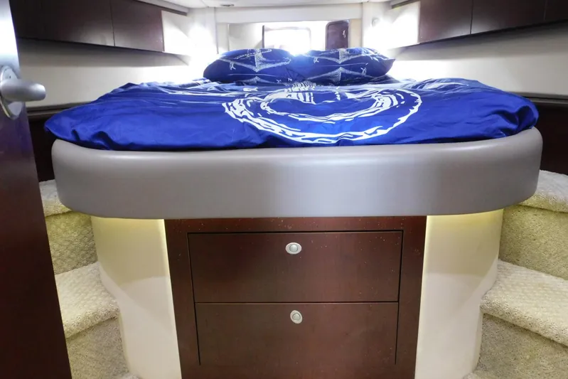 Full Deck Yacht Photos Pics Luxurious bedroom interior of 2008 Sea Ray 44 Sedan Bridge yacht with blue bedding.