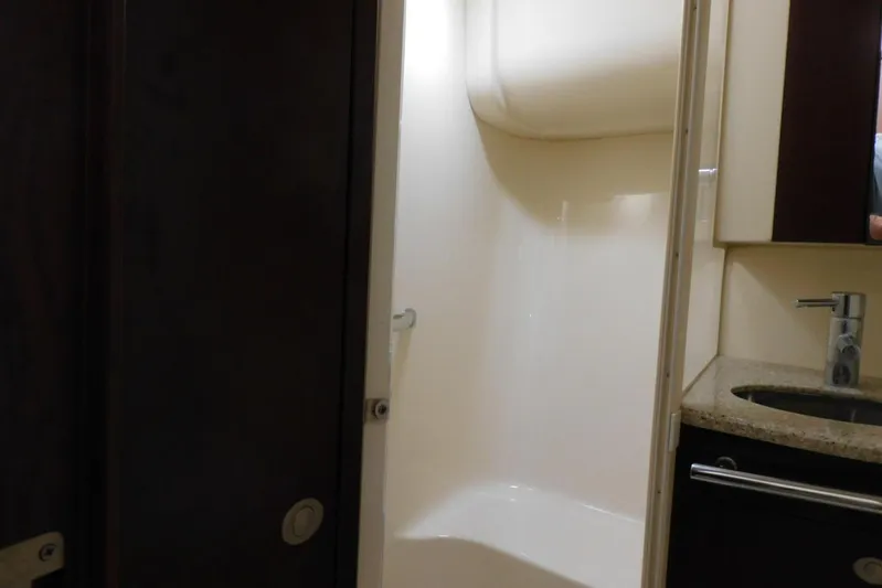 Full Deck Yacht Photos Pics Bathroom interior of 2008 Sea Ray 44 Sedan Bridge yacht, featuring shower and sink.