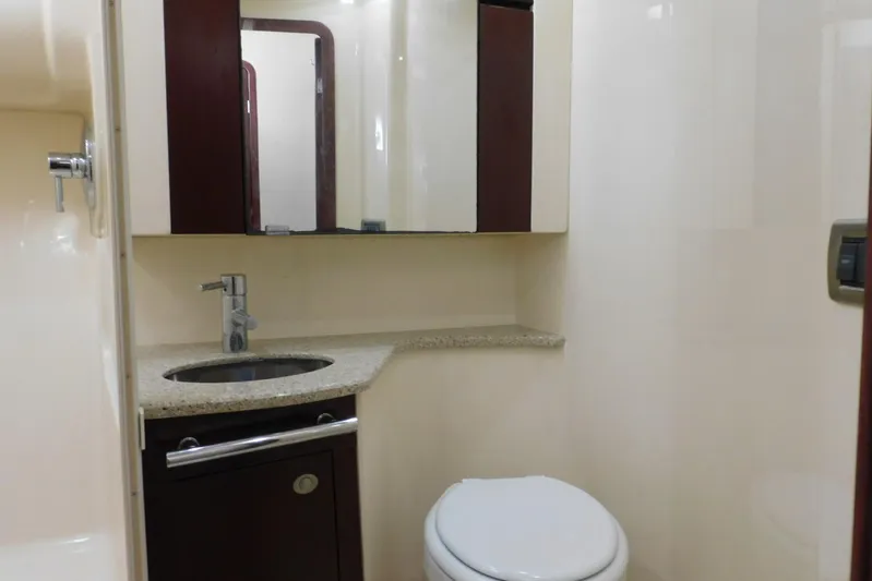 Full Deck Yacht Photos Pics Luxurious bathroom in 2008 Sea Ray 44 Sedan Bridge yacht, featuring modern sink and toilet.