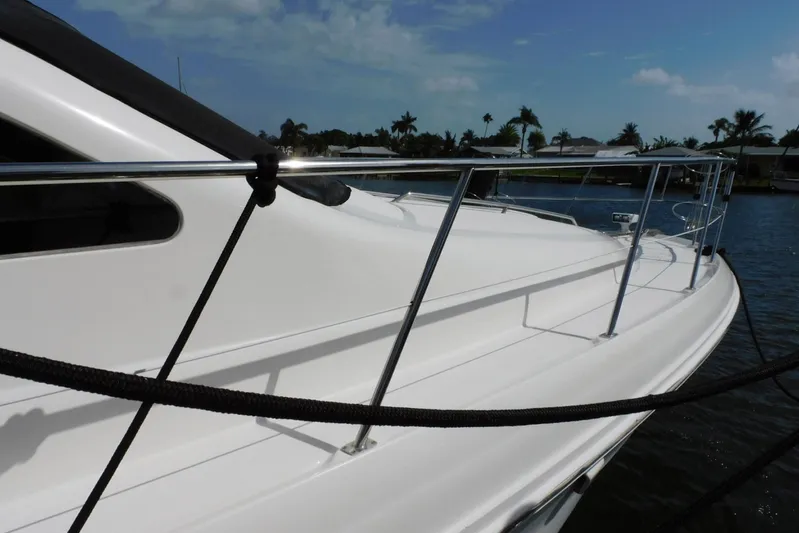 Full Deck Yacht Photos Pics 2008 Sea Ray 44 Sedan Bridge yacht docked, featuring sleek white deck and railing.