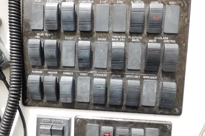 Full Deck Yacht Photos Pics Control panel of a 2008 Sea Ray 44 Sedan Bridge with various switches and labels.