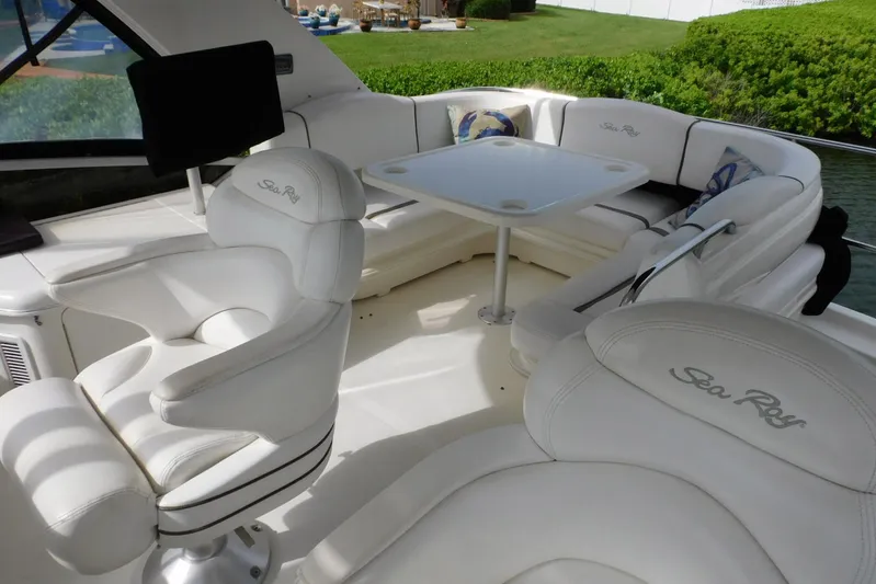 Full Deck Yacht Photos Pics Luxurious 2008 Sea Ray 44 Sedan Bridge yacht interior with plush seating and table.