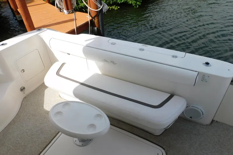 Full Deck Yacht Photos Pics 2008 Sea Ray 44 Sedan Bridge boat seating area with table, dockside view.