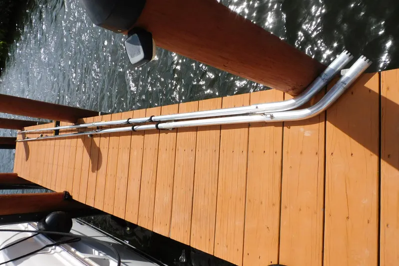 Full Deck Yacht Photos Pics Wooden dock with metal railings beside a 2008 Sea Ray 44 Sedan Bridge boat.