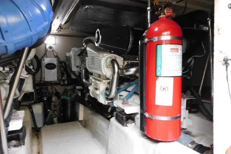 Full Deck Yacht Photos Pics Engine room of 2008 Sea Ray 44 Sedan Bridge with fire extinguisher and mechanical components.