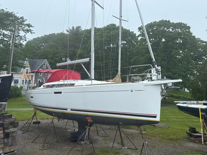 Statira Yacht Photos Pics 2017 Jeanneau Sun Odyssey 389 sailboat on stands, surrounded by trees and houses.