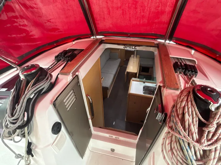 Statira Yacht Photos Pics Interior view of 2017 Jeanneau Sun Odyssey 389 sailboat with red canopy and ropes.