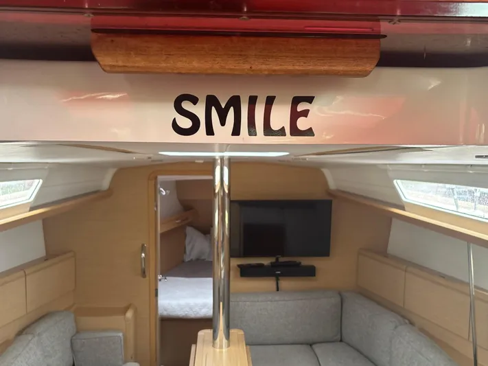 Statira Yacht Photos Pics Interior of 2017 Jeanneau Sun Odyssey 389 sailboat with "Smile" sign.