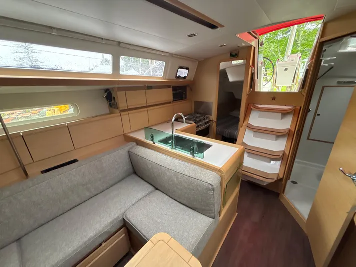 Statira Yacht Photos Pics Interior of 2017 Jeanneau Sun Odyssey 389 sailboat with modern kitchen and seating area.
