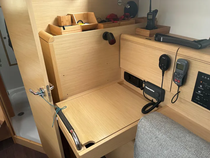 Statira Yacht Photos Pics Interior of 2017 Jeanneau Sun Odyssey 389 yacht with navigation equipment and wooden cabinetry.