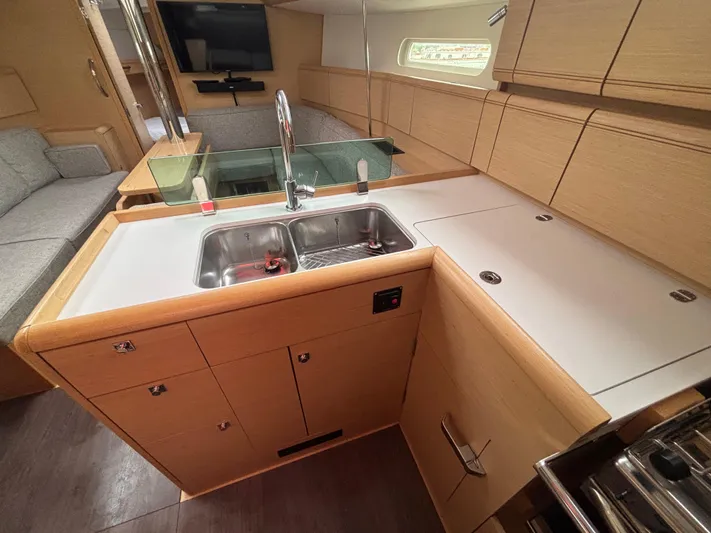 Statira Yacht Photos Pics Modern kitchen interior of 2017 Jeanneau Sun Odyssey 389 yacht with sleek cabinetry and sink.