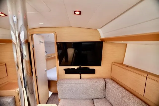 Statira Yacht Photos Pics Interior of 2017 Jeanneau Sun Odyssey 389 yacht with modern furnishings and TV.