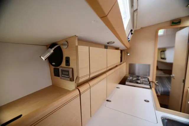 Statira Yacht Photos Pics 2017 Jeanneau Sun Odyssey 389 interior kitchen with modern cabinetry and appliances.