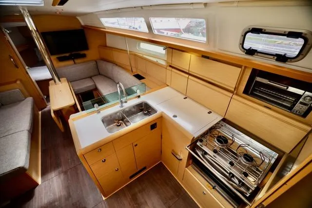 Statira Yacht Photos Pics Interior of 2017 Jeanneau Sun Odyssey 389 yacht, featuring modern kitchen and cozy seating area.