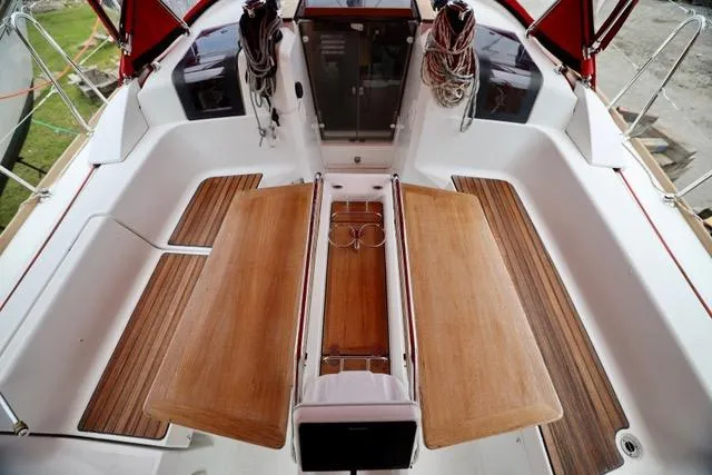 Statira Yacht Photos Pics Cockpit of 2017 Jeanneau Sun Odyssey 389 sailboat with wooden seating and rope storage.