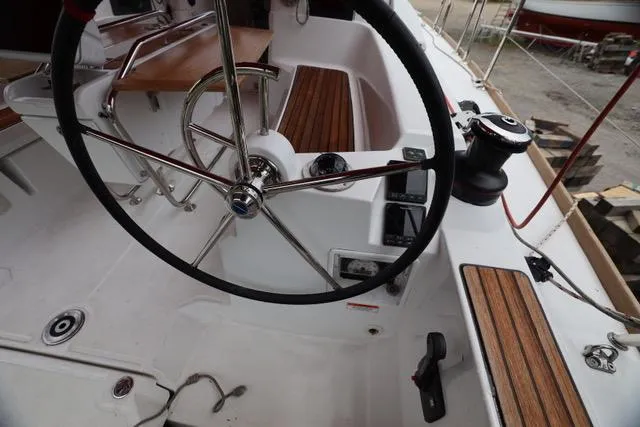 Statira Yacht Photos Pics Cockpit of 2017 Jeanneau Sun Odyssey 389 sailboat with steering wheel and wooden seating.