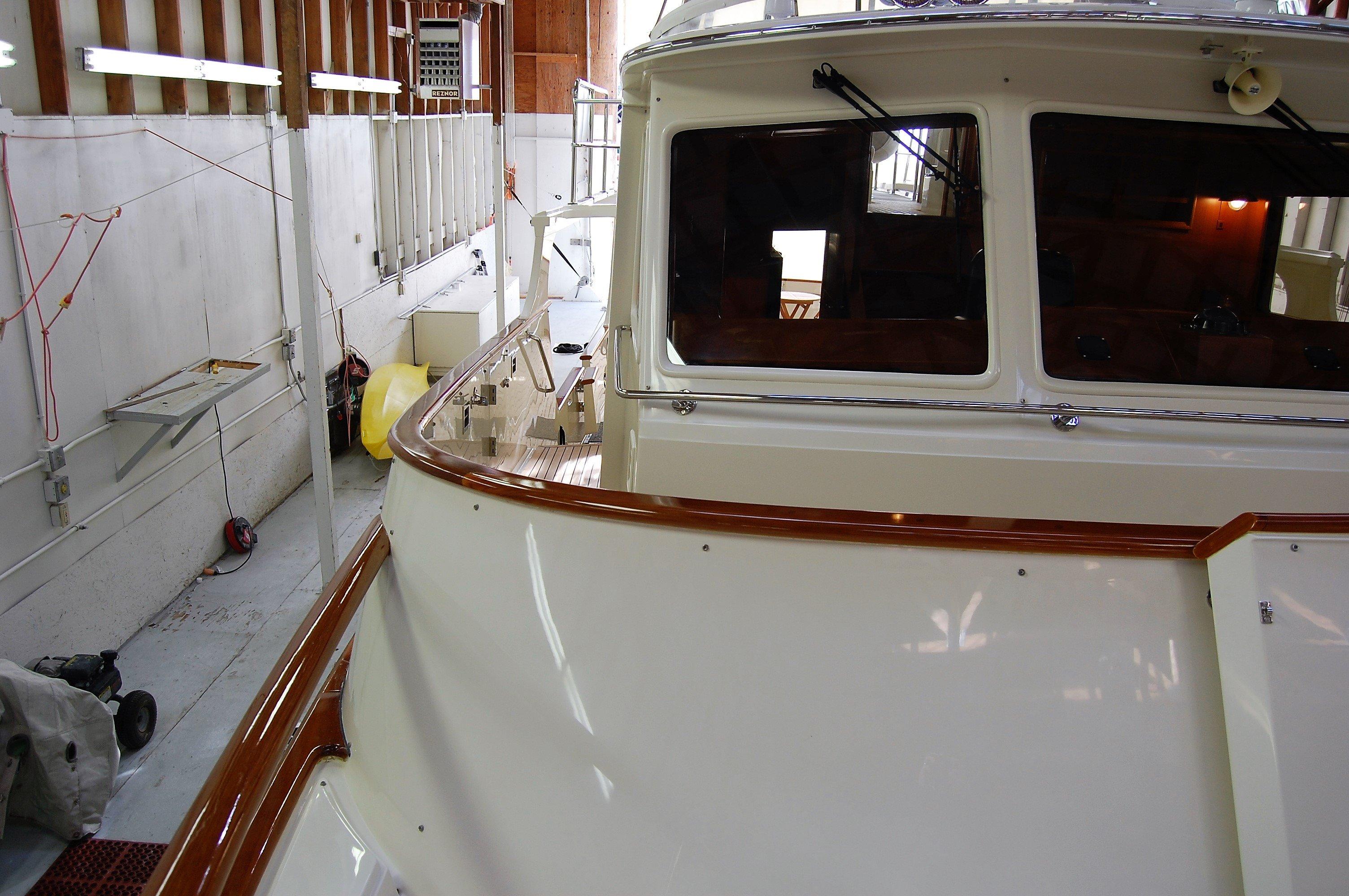 2009 Fleming Pilothouse yacht in a boatyard, showcasing its sleek design and craftsmanship.