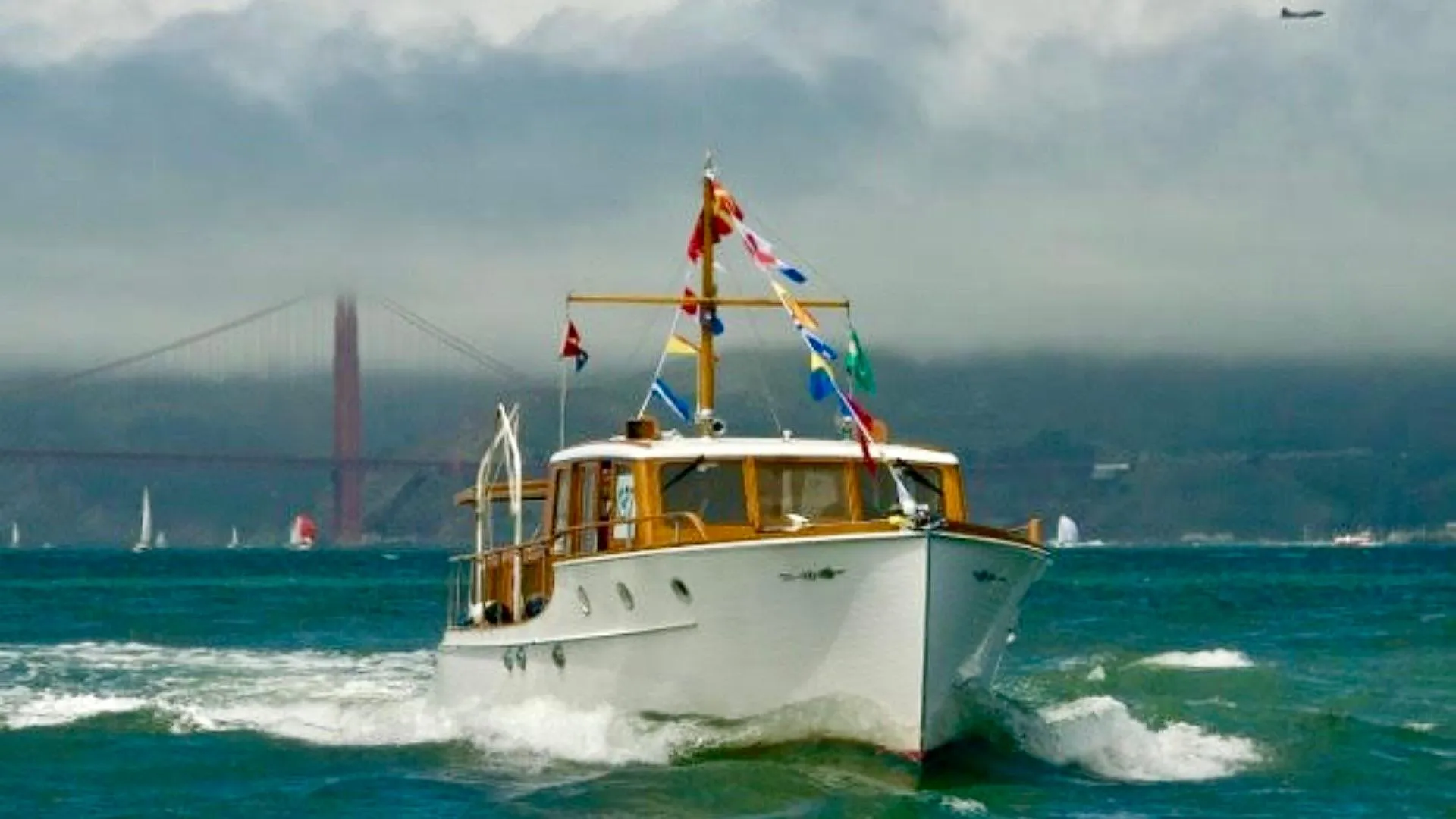 1939 Stephens Brothers Bridgedeck Cruiser on water, Golden Gate Bridge in background.