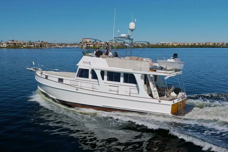 Magic Yacht Photos Pics 1996 Grand Banks 46 Europa cruising on calm waters, showcasing classic design and elegance.