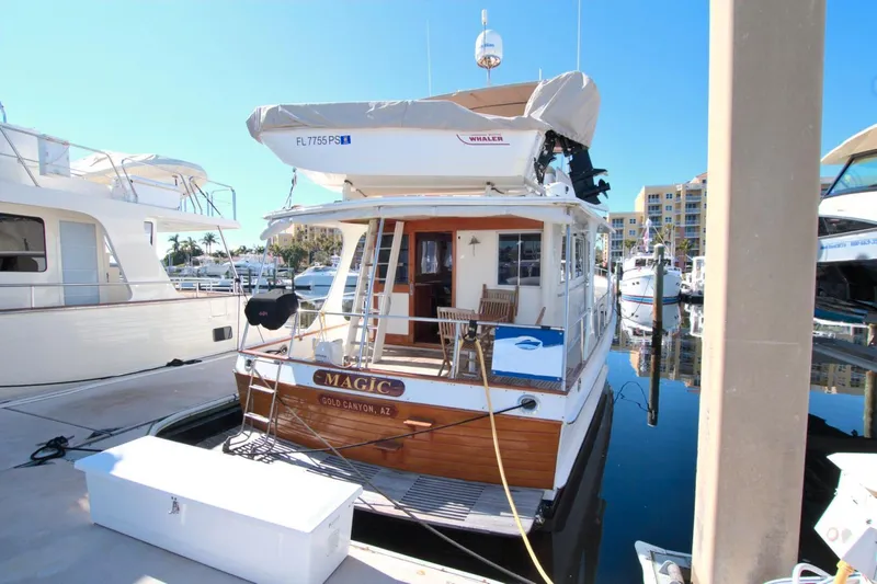 Magic Yacht Photos Pics Grand Banks 46 Europa 1996 yacht docked at marina, rear view with deck seating.