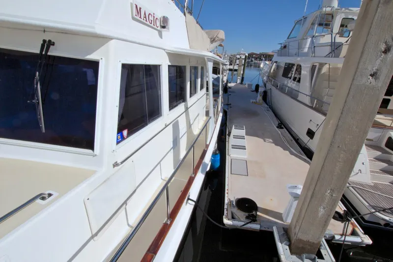 Magic Yacht Photos Pics 1996 Grand Banks 46 Europa yacht docked at marina, side view.