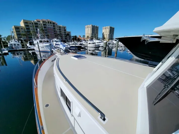 Magic Yacht Photos Pics Grand Banks 46 Europa 1996 yacht docked in marina with cityscape background.