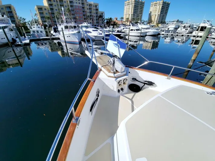 Magic Yacht Photos Pics Grand Banks 46 Europa 1996 yacht docked in a marina with calm waters.