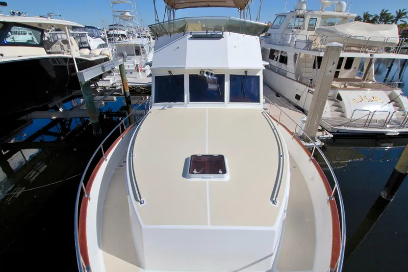 Magic Yacht Photos Pics 1996 Grand Banks 46 Europa yacht docked at marina, top deck view.
