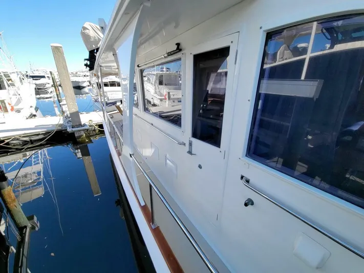 Magic Yacht Photos Pics 1996 Grand Banks 46 Europa yacht docked at marina, side view.