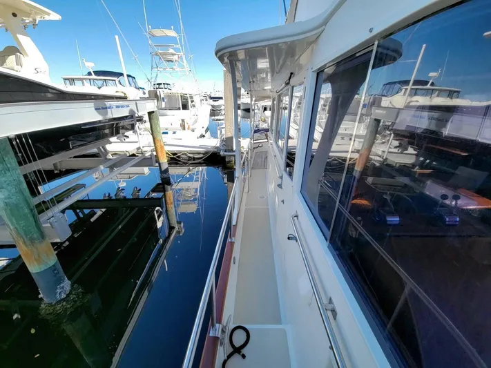 Magic Yacht Photos Pics Side deck view of 1996 Grand Banks 46 Europa yacht in marina.