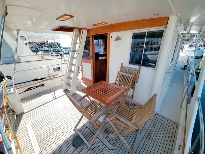 Magic Yacht Photos Pics 1996 Grand Banks 46 Europa yacht deck with wooden furniture and ladder.