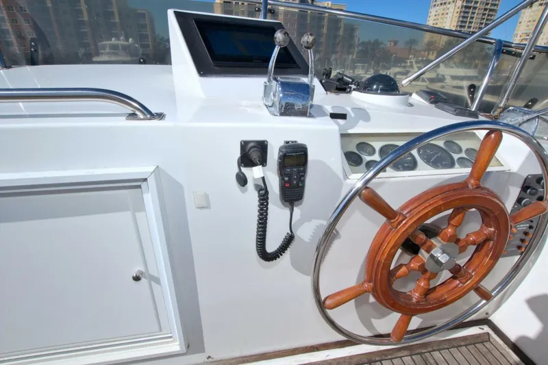 Magic Yacht Photos Pics 1996 Grand Banks 46 Europa helm with wooden wheel and navigation controls.
