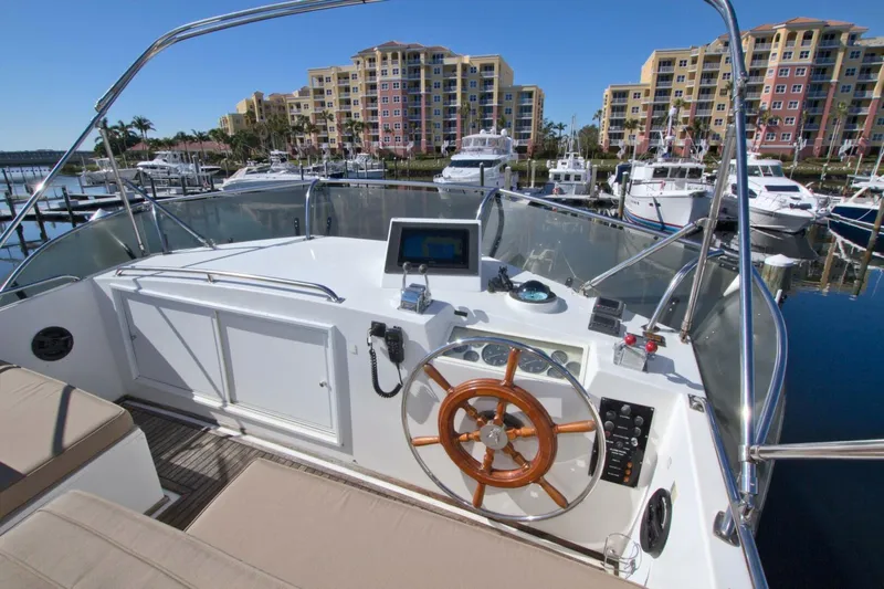 Magic Yacht Photos Pics 1996 Grand Banks 46 Europa yacht helm with marina view and modern navigation equipment.