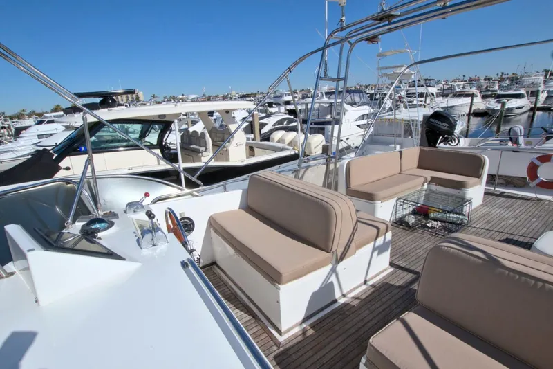 Magic Yacht Photos Pics 1996 Grand Banks 46 Europa yacht with spacious deck seating at a marina.