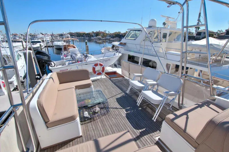 Magic Yacht Photos Pics 1996 Grand Banks 46 Europa yacht with spacious deck and seating in marina.