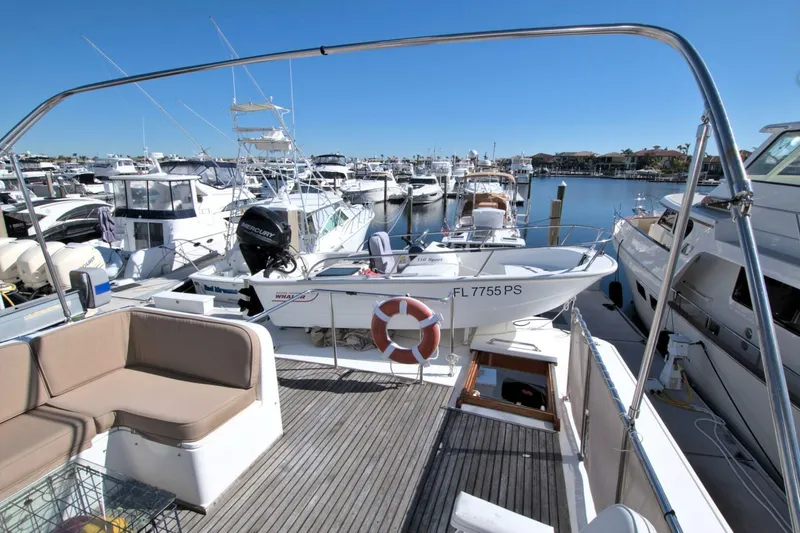 Magic Yacht Photos Pics Grand Banks 46 Europa 1996 yacht docked at marina with tender boat on deck.
