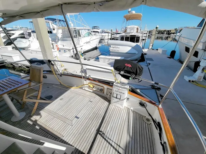 Magic Yacht Photos Pics 1996 Grand Banks 46 Europa yacht docked at marina, featuring spacious deck and seating area.