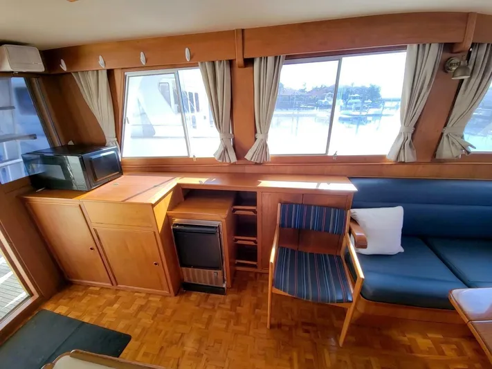 Magic Yacht Photos Pics Interior of 1996 Grand Banks 46 Europa yacht with wood furnishings and large windows.