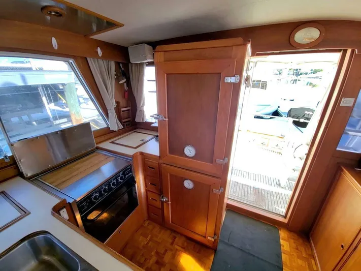 Magic Yacht Photos Pics Interior of 1996 Grand Banks 46 Europa yacht, featuring kitchen and wooden cabinetry.
