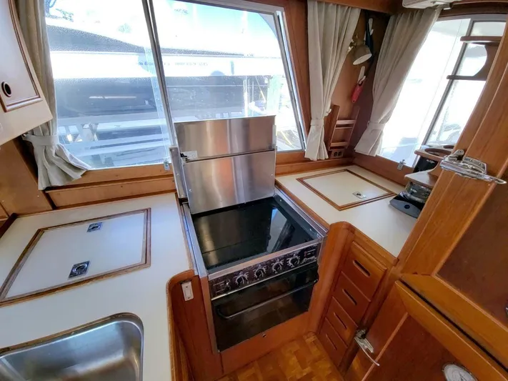 Magic Yacht Photos Pics Interior kitchen of 1996 Grand Banks 46 Europa yacht with stove and sink.