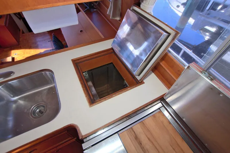 Magic Yacht Photos Pics Interior of 1996 Grand Banks 46 Europa yacht, featuring a kitchen sink and storage hatch.