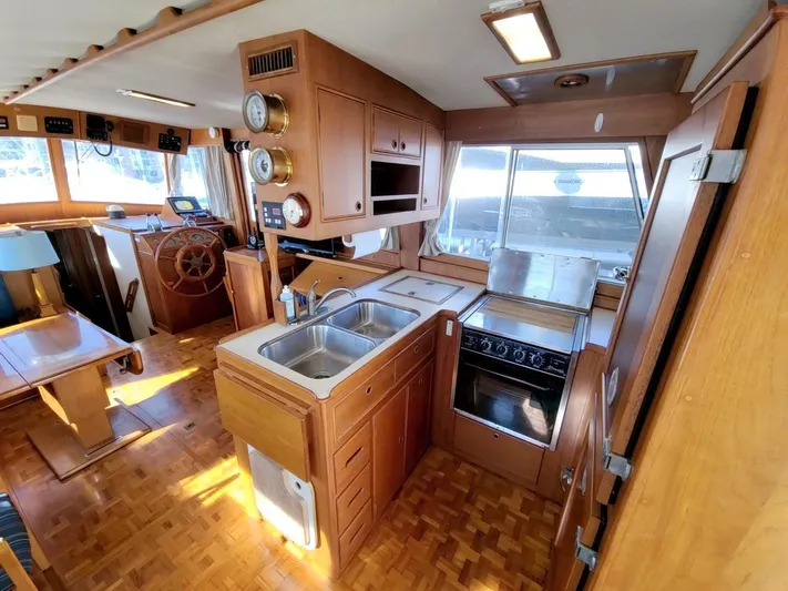 Magic Yacht Photos Pics Interior of 1996 Grand Banks 46 Europa yacht, featuring kitchen and helm area.