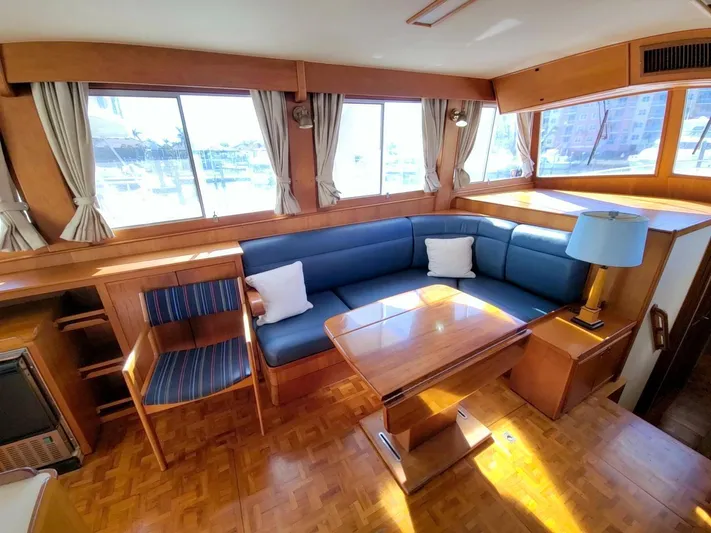 Magic Yacht Photos Pics Interior of 1996 Grand Banks 46 Europa yacht with blue seating and wooden furnishings.